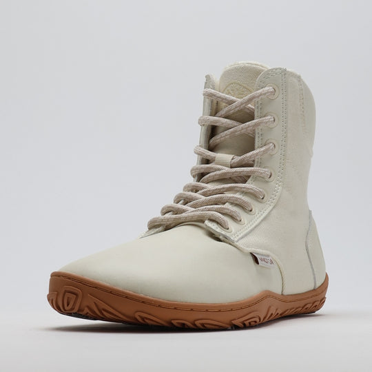 Single off white barefoot winter boot shown from a front angle on a light gray background.