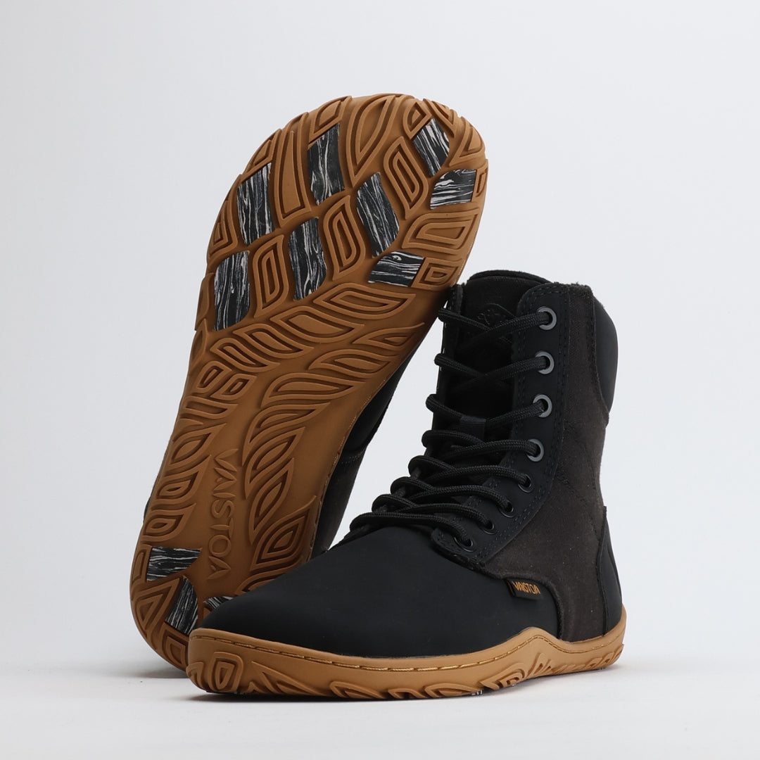 Black barefoot winter boots with the “Design from Finland” label, showcasing minimalist Nordic design focused on warmth, lightness, and natural movement.