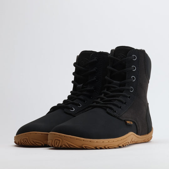 Pair of black barefoot winter boots shown from a front angle on a light gray background.