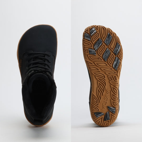 Black barefoot winter boot showing a wide anatomical toe box on a light gray background.