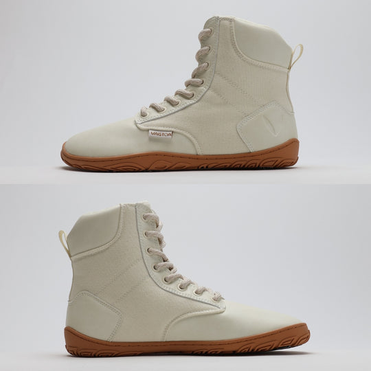Off white barefoot winter boot showing a flat zero-drop sole from medial and lateral angles on a light gray background.