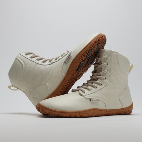 Off white barefoot winter boot with the sole resting against the upper, showing visible grip zones on the Vaistoa Pitoa™ winter sole.