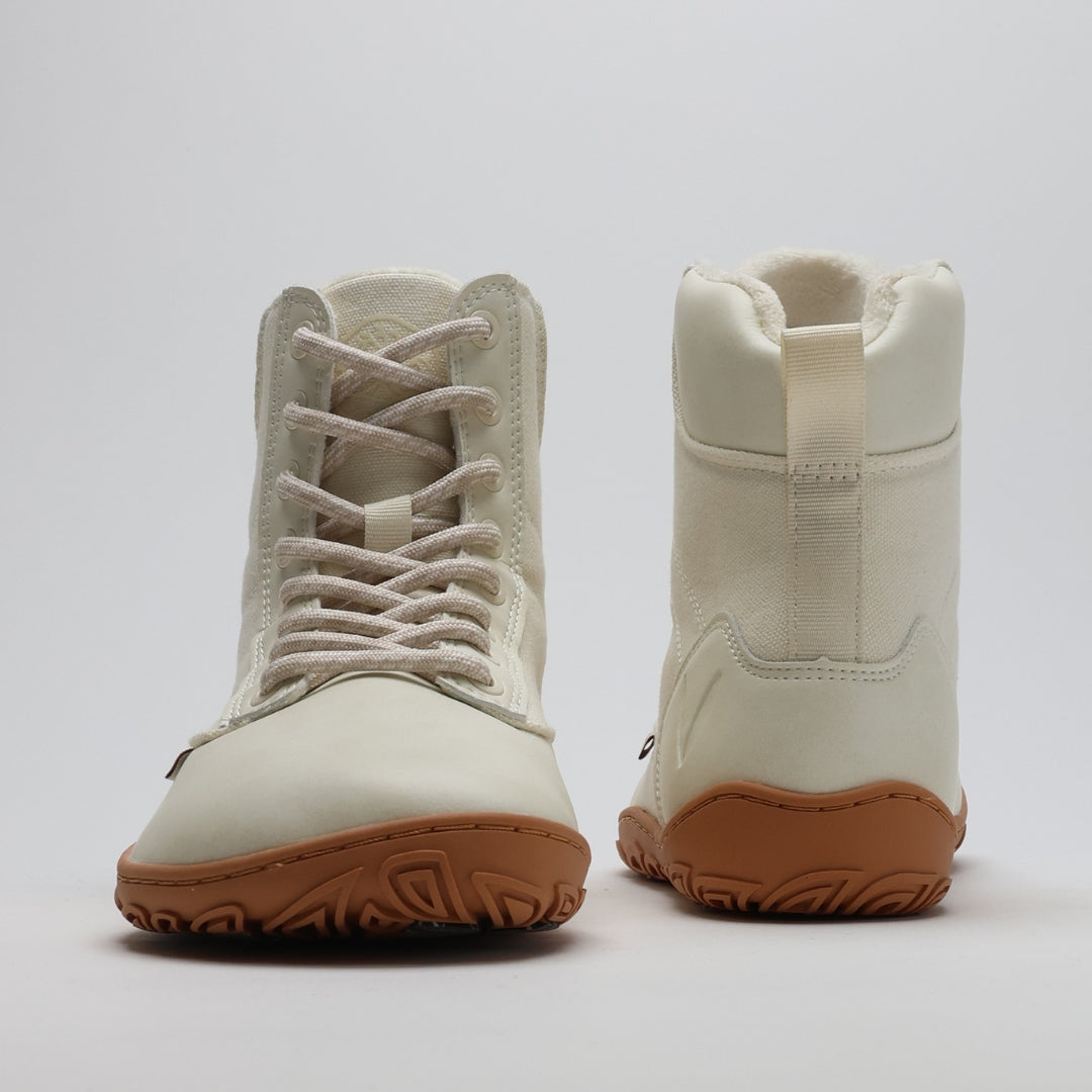 Pair of off white barefoot winter boots shown from the front and back on a light gray background.