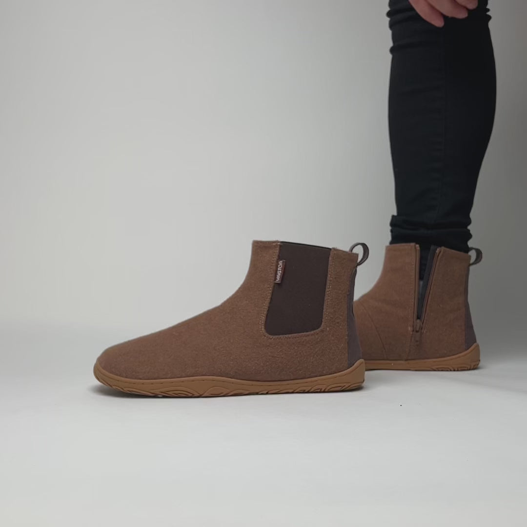 Video showing how to put on the Vaistoa Sulo barefoot winter felt ankle boots in Roasted Almond color. Demonstrates the flexible structure, cozy lining, and easy slip-on Chelsea design.