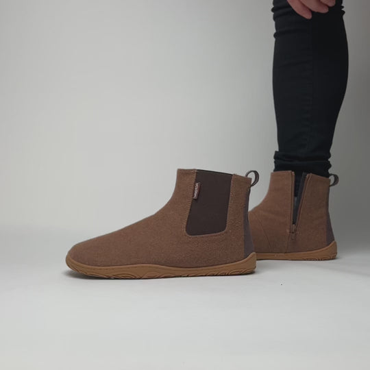Video showing how to put on the Vaistoa Sulo barefoot winter felt ankle boots in Roasted Almond color. Demonstrates the flexible structure, cozy lining, and easy slip-on Chelsea design.