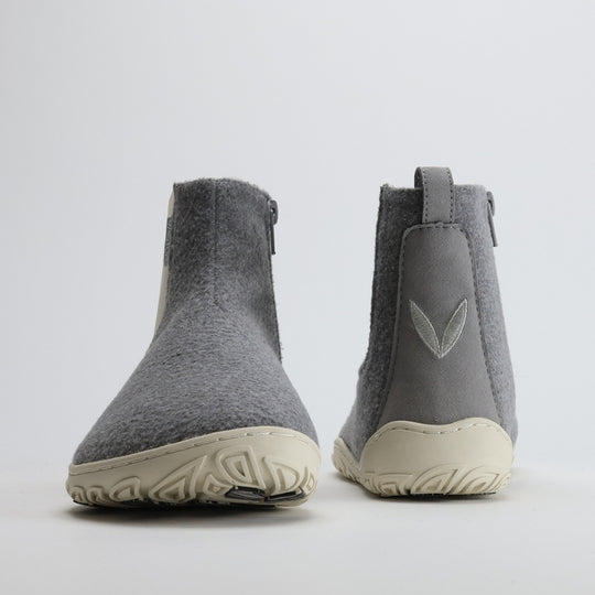 Pair of pearl grey barefoot winter felt Chelsea boots shown from the front and back on a light gray background, highlighting their balanced design, wide toe box, and minimalist Nordic style.