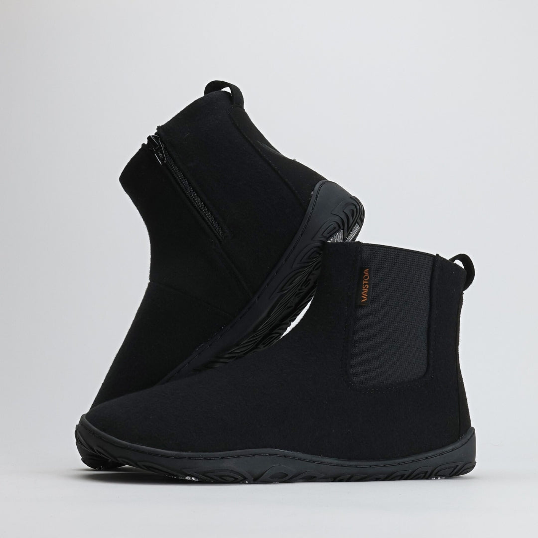 Velvet black barefoot winter felt Chelsea boots with the “Design from Finland” label, showcasing Nordic craftsmanship, warmth, and natural barefoot comfort for winter conditions.