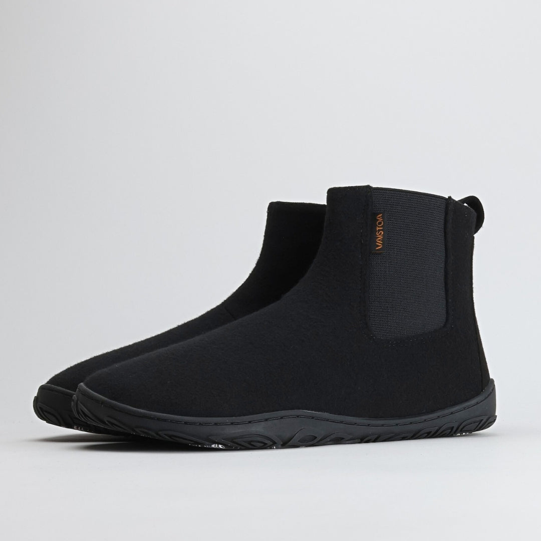 Pair of velvet black barefoot winter felt Chelsea boots shown from a front angle on a light gray background, highlighting their elegant design and warm felt texture.