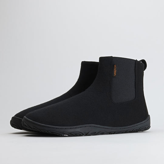 Pair of velvet black barefoot winter felt Chelsea boots shown from a front angle on a light gray background, highlighting their elegant design and warm felt texture.