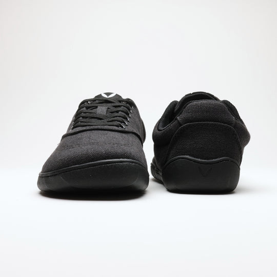Vaistoa Huoleton barefoot hemp sneakers – soft black, pair with one shoe photographed from the front and the other from behind, the heel loop visible