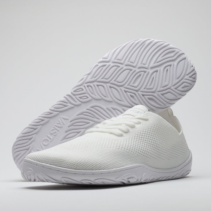 Vaistoa Iloa knitted barefoot sneakers – pair shown with one shoe from a front side angle and the other tilted to reveal the patterned sole, against a light background