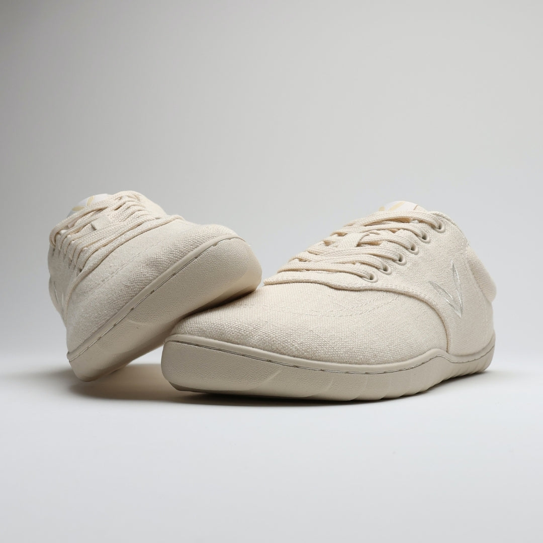 Vaistoa Huoleton barefoot hemp sneakers – natural hemp, pair with one shoe leaning on the other, side profiles and the thin sole visible, light background