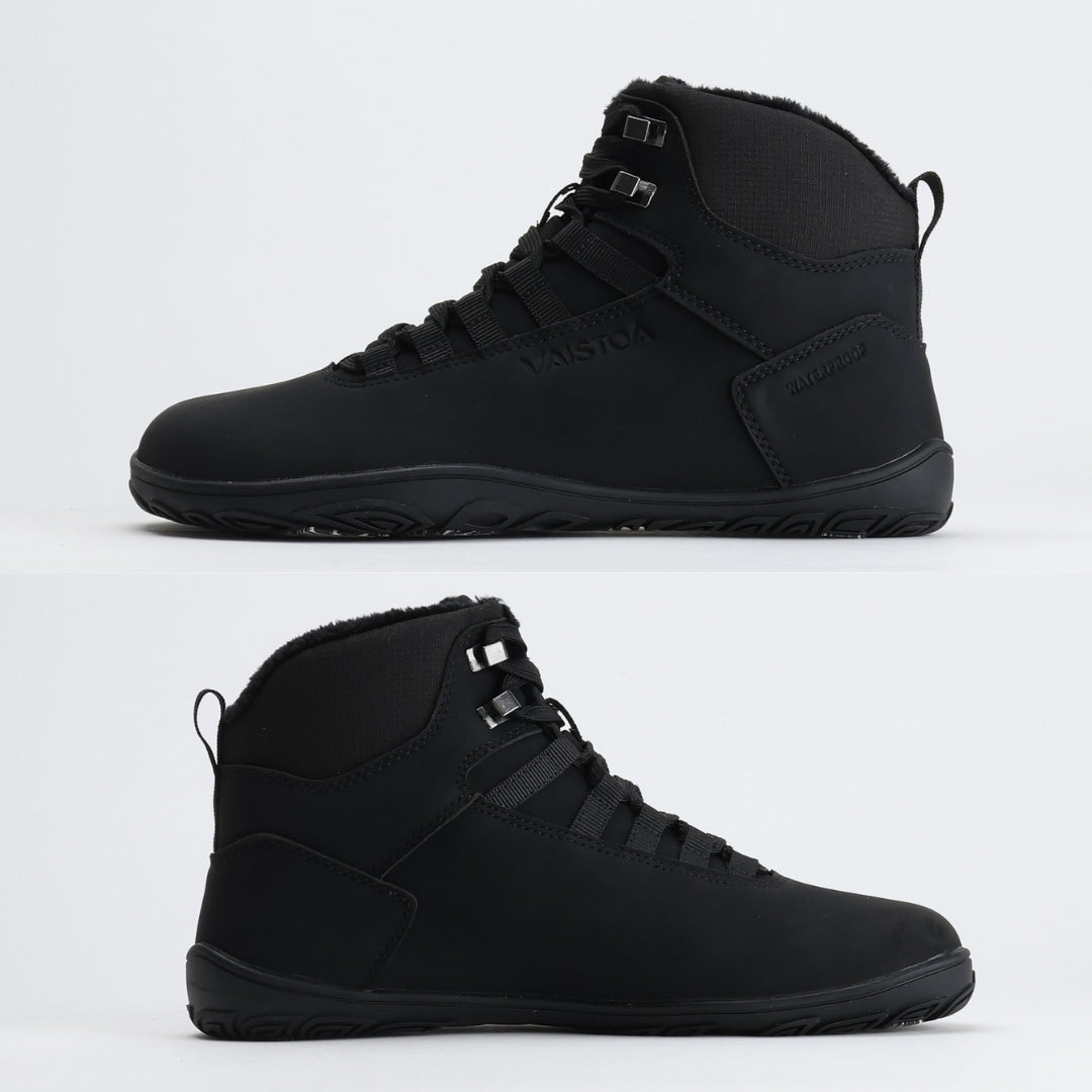 Black barefoot hiking boot showing a flat zero-drop sole from medial and lateral angles on a light gray background.