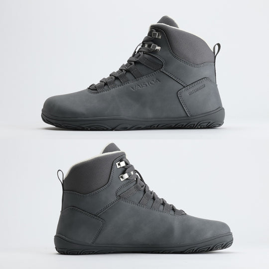 Frost gray barefoot hiking boot showing a flat zero-drop sole from medial and lateral angles on a light gray background.