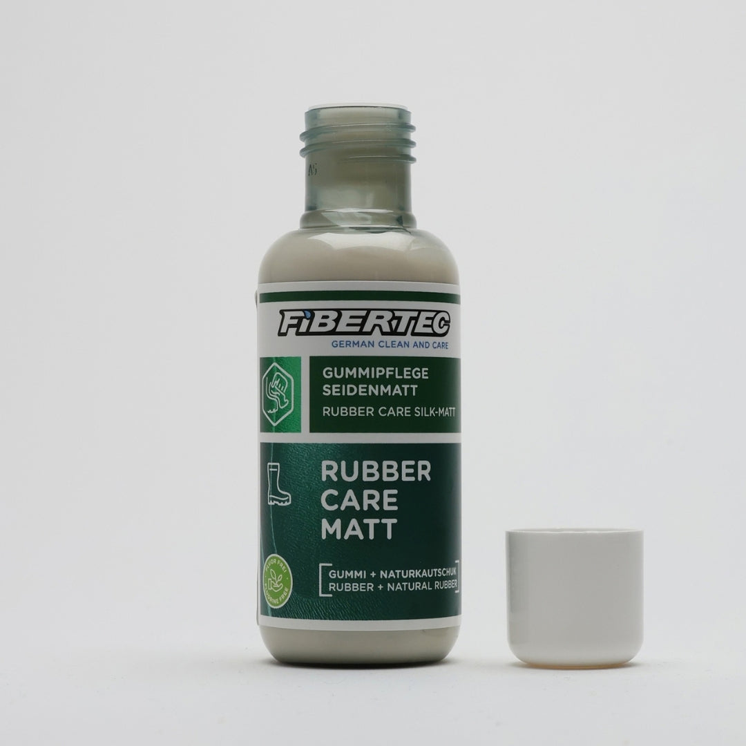Rubber boot conditioner bottle opened with the white cap beside it