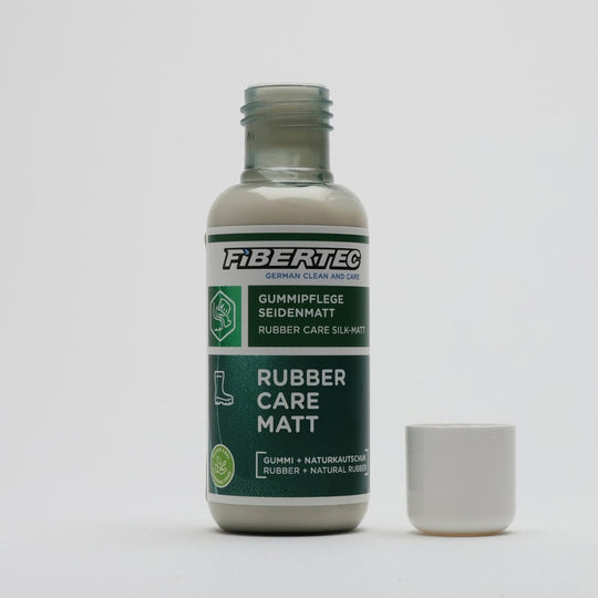 Rubber boot conditioner bottle opened with the white cap beside it