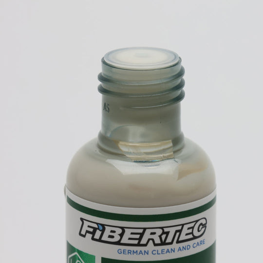 Close-up of the open bottle showing the light care emulsion at the mouth