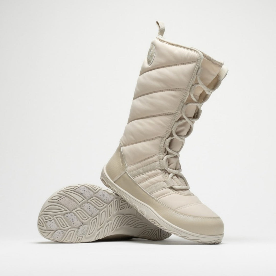 Vaistoa Hanki 3 barefoot winter snow boots, colour Vanilla – studio photo: one boot standing, the other lying with the sole and Pitoa grip pads visible.