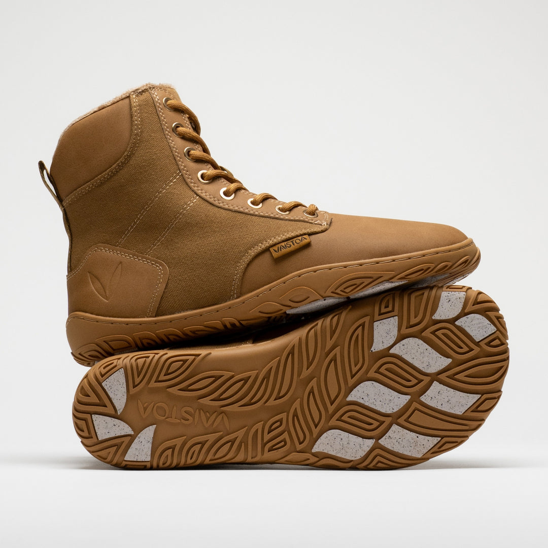 Vaistoa Hurmos 3 casual winter barefoot boots – one shoe standing on top of the other shoe's outsole, with the Vaistoa logo and grip pads visible on the outsole below