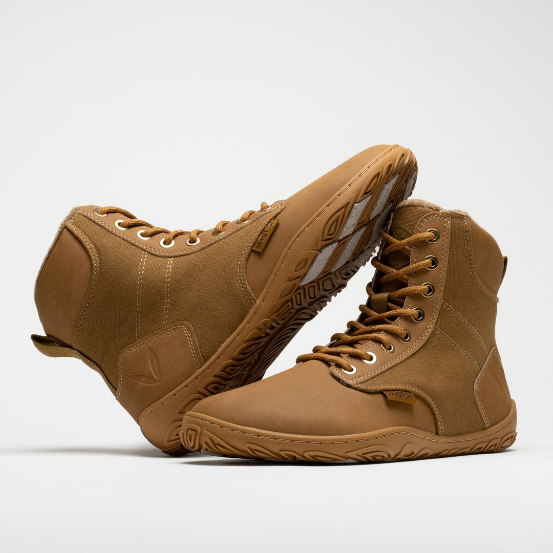 Vaistoa Hurmos 3 casual winter barefoot boots – pair with one shoe leaning horizontally against the shaft of the standing shoe, showing its outer side and the edge of the outsole