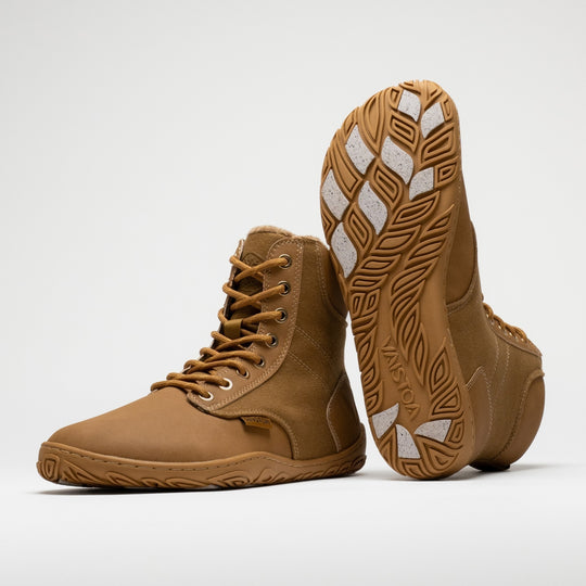 Vaistoa Hurmos 3 casual winter barefoot boots – pair with one shoe standing and the other leaning upright against its shaft with the outsole facing the camera, showing the Vaistoa logo and grip pads