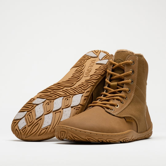 Vaistoa Hurmos 3 casual winter barefoot boots – pair with one shoe lying on its side with the outsole and grip pads facing the camera and the other standing next to it