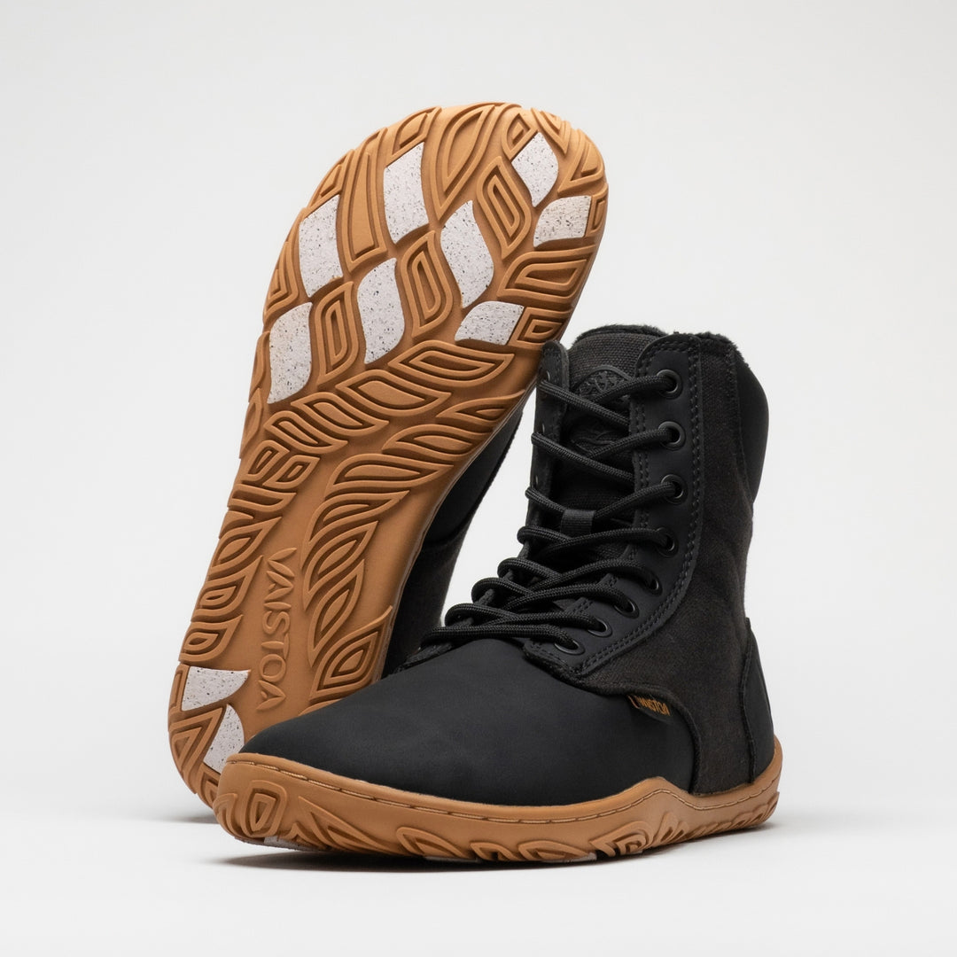 Vaistoa Hurmos 3 casual winter barefoot boots – pair with one shoe upright with the outsole and light grip pads facing the camera and the other standing in front of it at a front angle, against a light background