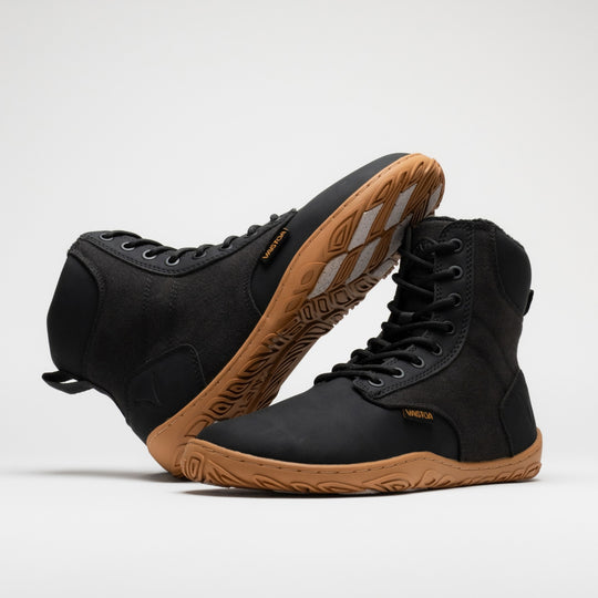 Vaistoa Hurmos 3 casual winter barefoot boots – pair with one shoe leaning horizontally against the shaft of the standing shoe, showing its outer side and the edge of the outsole