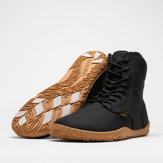 Vaistoa Hurmos 3 casual winter barefoot boots – pair with one shoe lying on its side with the outsole and grip pads facing the camera and the other standing next to it