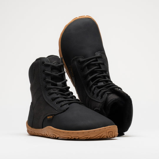 Vaistoa Hurmos 3 casual winter barefoot boots – pair with the front shoe at a front angle and the second shoe upside down behind it, showing the faux fur lining at the shaft opening