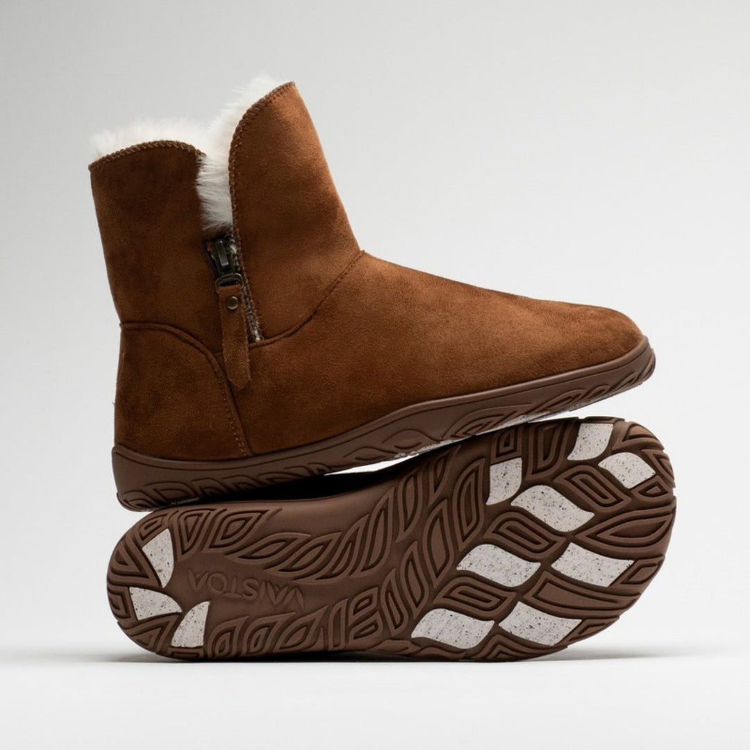 Vaistoa Huurre 2 barefoot winter ankle boots, colour Caramel brown – studio photo: one boot resting on the sole of the other.