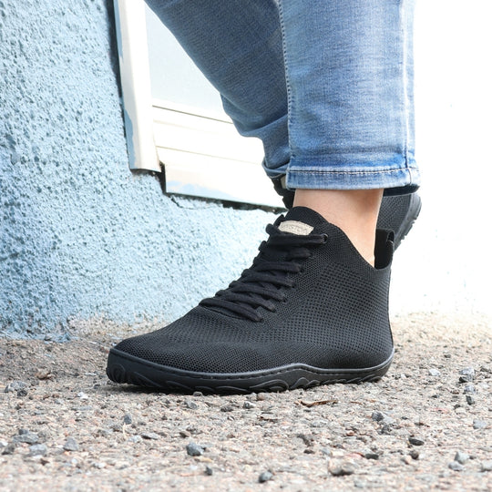 vaistoa iloa mid barefoot shoes knitted high top sneakers black lifestyle spring step on asphalt blue wall