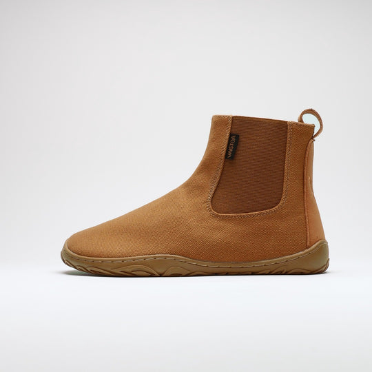 Vaistoa Kajo 2 barefoot chelsea boots – almond brown shoe shown from the side with the elastic panel visible, flat zero-drop sole against a light background