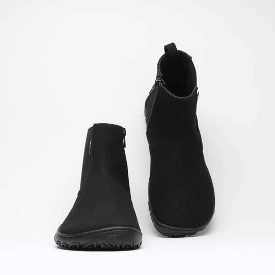 Vaistoa Kajo 2 barefoot chelsea boots – classic black pair shown from a high angle, wide toe box and both side zippers visible against a light background