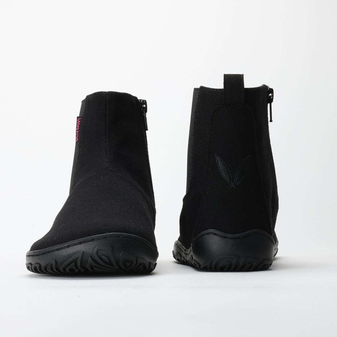 Vaistoa Kajo barefoot Chelsea boots – black, studio shot of the pair, one boot from the front and the other from behind, zipper and heel loop visible