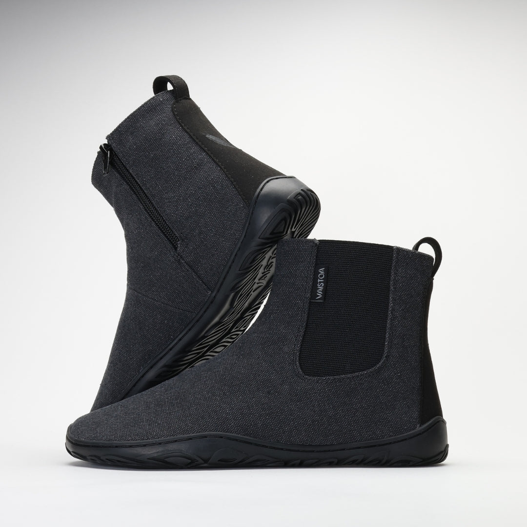 Vaistoa Kajo barefoot Chelsea boots – smoky stonewashed grey, studio shot of the pair, the back boot tilted so the outsole shows and the front boot side-on with the elastic panel and heel loop visible, light background