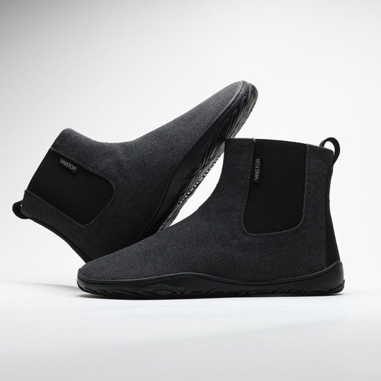 Vaistoa Kajo barefoot Chelsea boots – smoky stonewashed grey, studio shot of the pair, the back boot tilted onto the front one, elastic side panel and the Vaistoa label visible