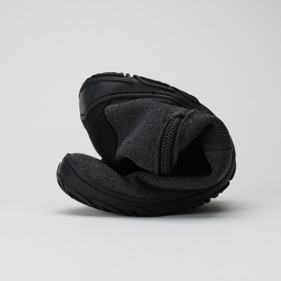 Vaistoa Kajo barefoot Chelsea boots – smoky stonewashed grey, studio shot of two boots stacked, the upper one bent over to show how flexible the upper is, side zipper visible