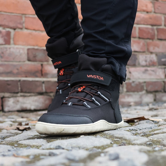 vaistoa kaste waterproof kids barefoot shoes black lifestyle spring cobblestones brick wall