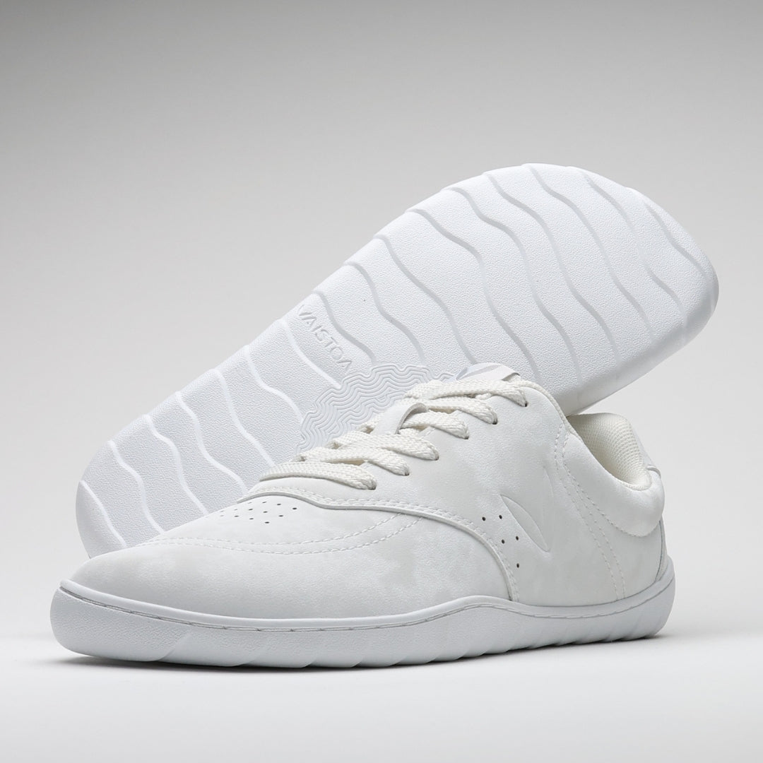 Vaistoa Katu 2 white barefoot sneakers – minimalist leather-like surface and flat, flexible sole. One shoe pictured with sole visible, featuring the Design from Finland mark.