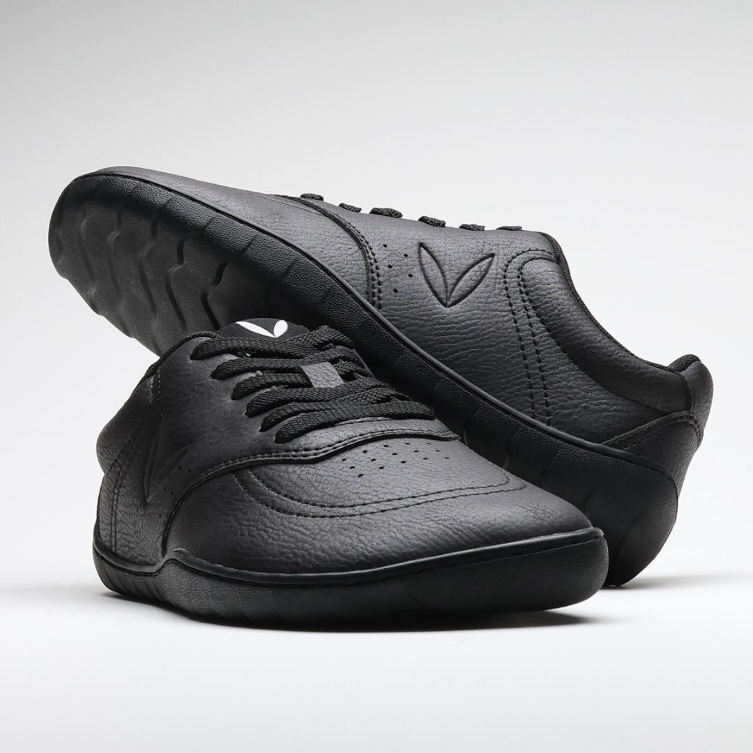 Vaistoa Katu 2 black barefoot sneakers – stylishly arranged so that one shoe rests on top of the other, emphasizing the minimalist design and sleek silhouette.