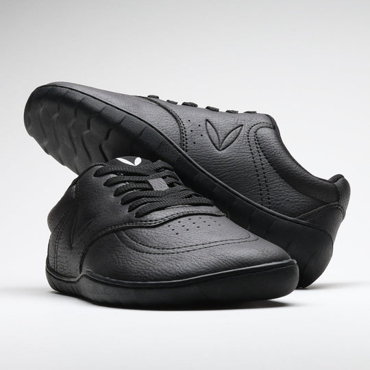 Vaistoa Katu 2 black barefoot sneakers – stylishly arranged so that one shoe rests on top of the other, emphasizing the minimalist design and sleek silhouette.