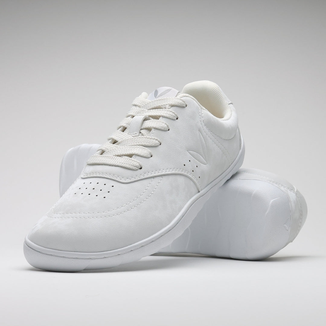 Vaistoa Katu 2 white barefoot sneakers – stylishly arranged so that one shoe leans against the sole of the other, highlighting the minimalist design and flexibility of the thin sole.