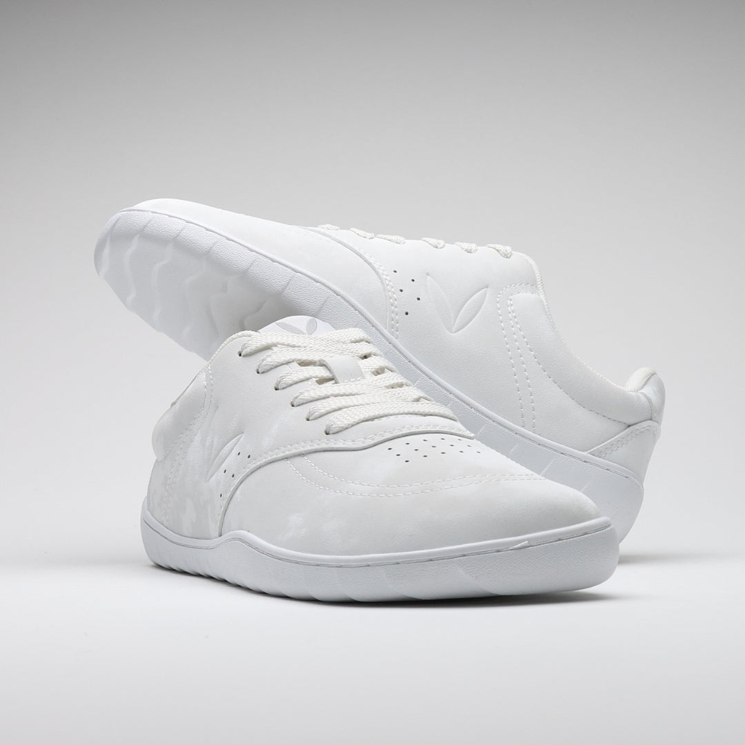 Vaistoa Katu 2 white barefoot sneakers – stylishly arranged so that one shoe rests on top of the other, emphasizing the minimalist design and sleek silhouette.