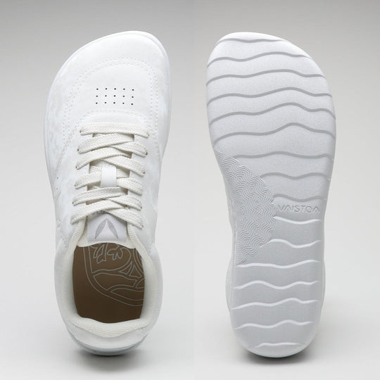 Vaistoa Katu 2 white barefoot sneakers – top view showing a wide, foot-shaped toe box, and sole view showing a thin, flexible sole with a wavy pattern.