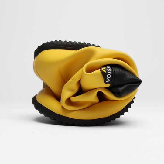 Vaistoa Katve 2 barefoot rubber boots yellow rolled up into a bundle the size of a palm