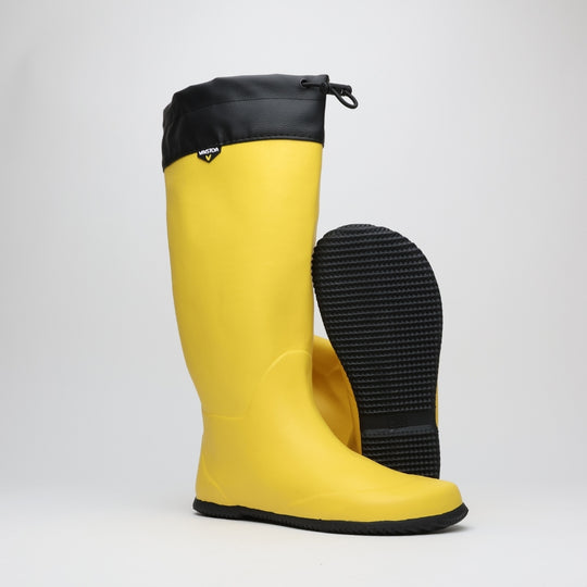 Vaistoa Katve 2 barefoot rubber boots yellow pair at a front angle with one boot tilted to show the patterned sole