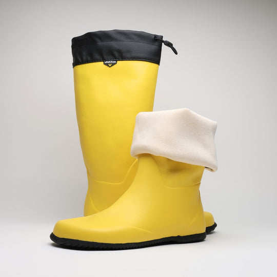 Vaistoa Katve 2 barefoot rubber boots yellow pair with one shaft folded down to show the natural white textile lining
