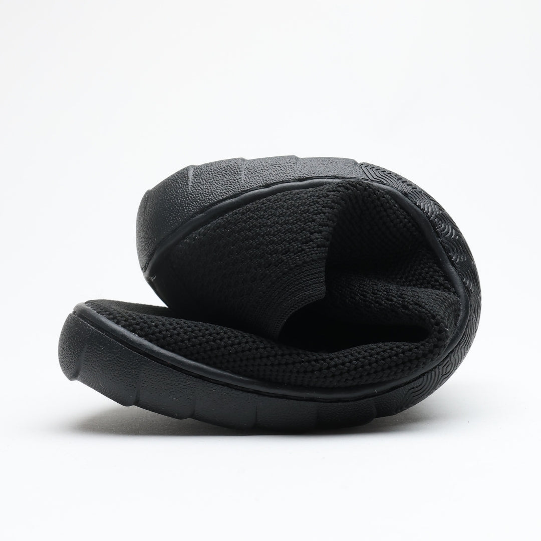 Black Vaistoa Lempeä 3 slip-on barefoot shoe folded to show flexible sole and knit upper
