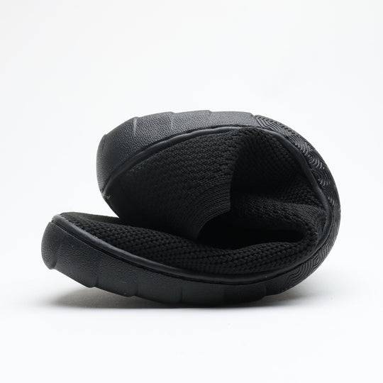 Black Vaistoa Lempeä 3 slip-on barefoot shoe folded to show flexible sole and knit upper